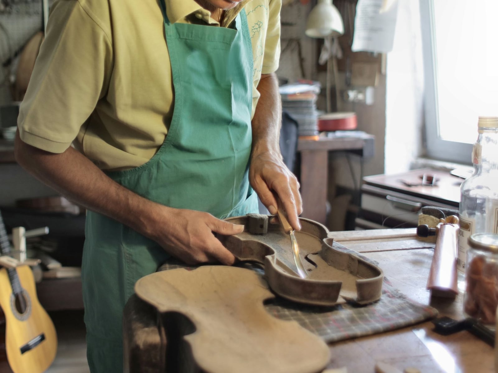 Beratungsgespräch zwischen einem Instrumentenbauer und einem Kunden über einen individuellen Gitarrenbau
